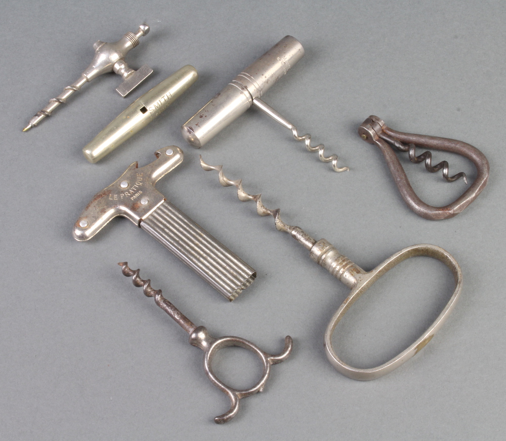 A 19th Century polished steel corkscrew, a folding corkscrew, a travelling corkscrew marked George