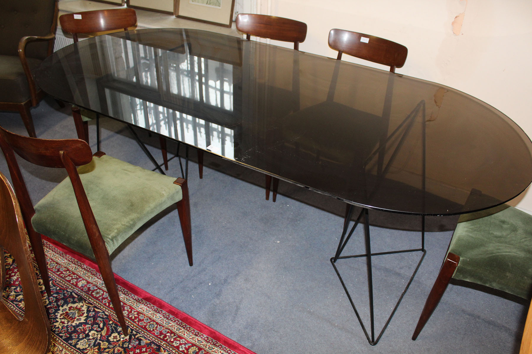 A SMOKED GLASS DINING TABLE