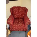 A RED UPHOLSTERED ARMCHAIR