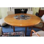 A LARGE CIRCULAR DINING TABLE