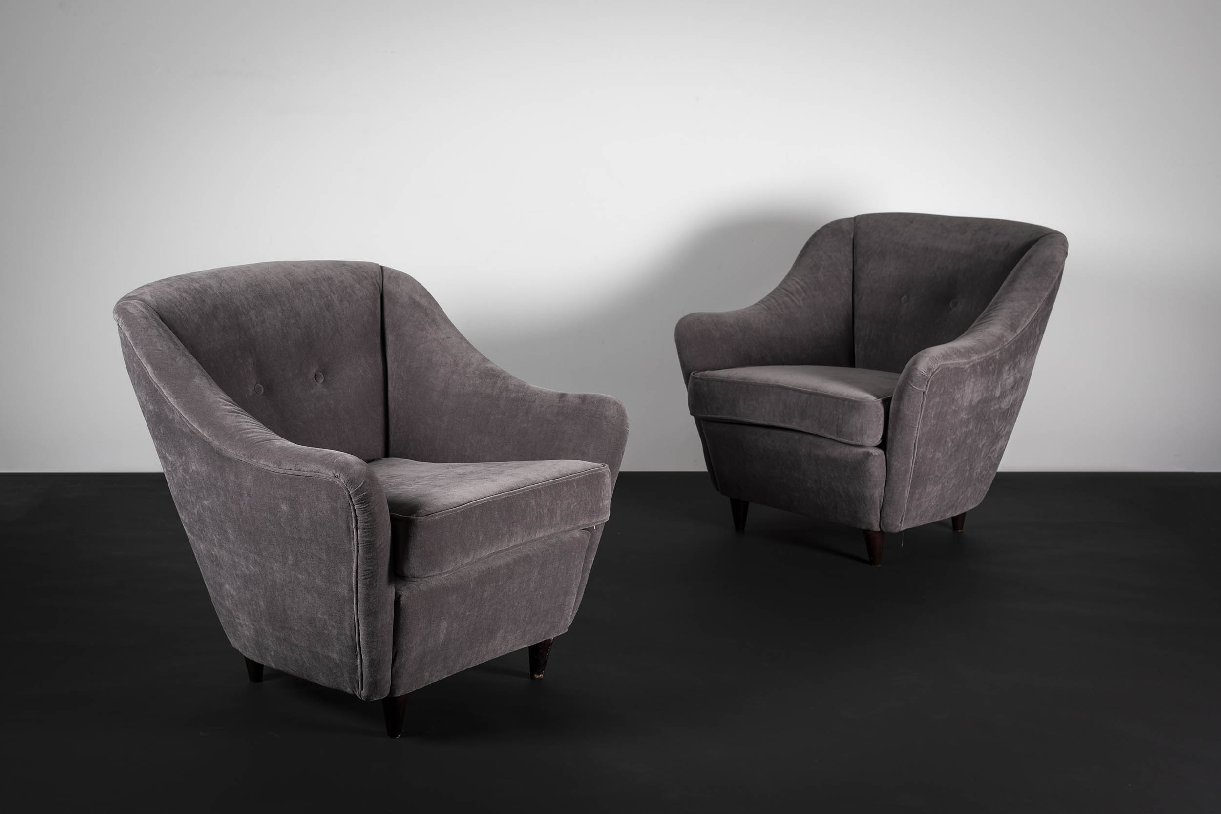 A PAIR OF UPHOLSTERED TUB CHAIRS