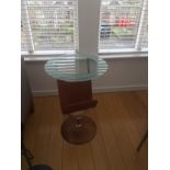 A CIRCULAR OCCASIONAL TABLE BY BOB BUSHELL, with magazine holder, 73cm (h) x 50cm (d)