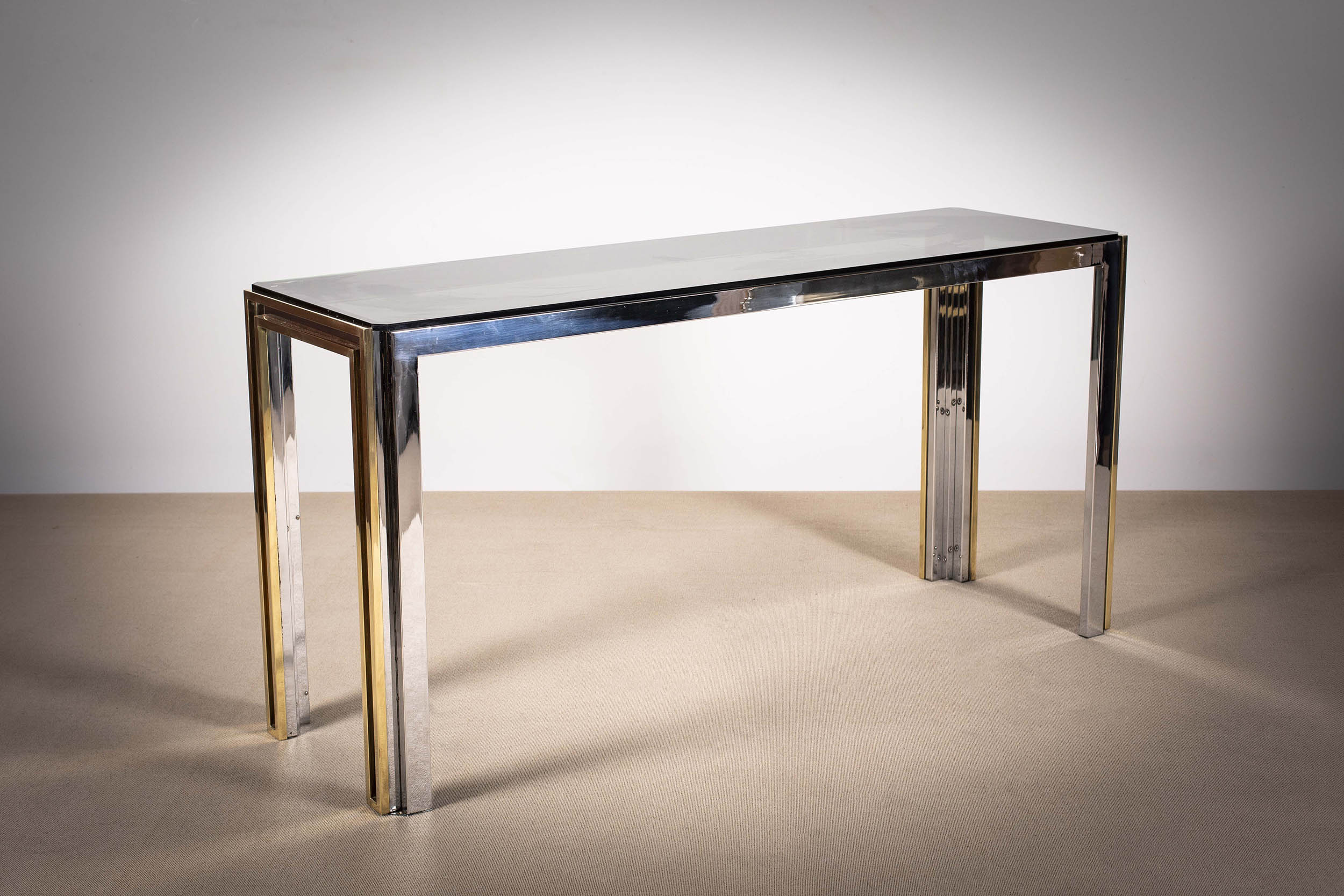 A CHROME AND GILT CONSOLE TABLE, ITALIAN 1960s, with smoked glass inset top,145cm (w) x 45cm (d) x