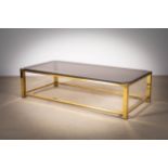 A GILT METAL RECTANGULAR LOW TABLE, FRENCH 1970s, with smoked glass, 135cm x 65cm x 35cm