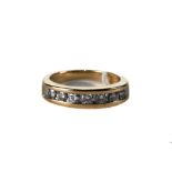 A 10K YELLOW GOLD SEVEN STONE DIAMOND HALF ETERNITY RING, stamped 10k, approximately 8.1 grams.