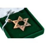 A 9CT YELLOW GOLD STAR OF DAVID PENDANT, stamped 9ct approximately 11.6 grams.