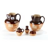 A LATE 19TH CENTURY LAMBETH DOULTON STONEWARE THREE-PIECE CONDIMENT SET with toper and hound