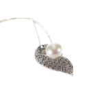 A 9CT WHITE GOLD PEARL AND DIAMOND PENDANT on a 9ct white gold neckchain, approximately 5 grams.