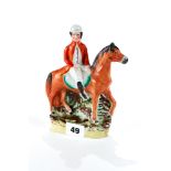 A RARE 19TH CENTURY STAFFORDSHIRE POTTERY FIGURE OF A JOCKEY ON A HORSE, 7 ins high.