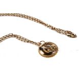 A 9CT YELLOW GOLD CIRCULAR MAN IN THE MOON PENDANT on a 9ct gold CHAIN, approximately 9.3 grams.