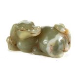 A CHINESE CELADON GREEN JADE CARVING OF A RECUMBENT DOG, 3 ins long.