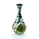 A MOORCROFT POTTERY VASE designed by Wendy Mason, decorated with green flowers and leaves, signed