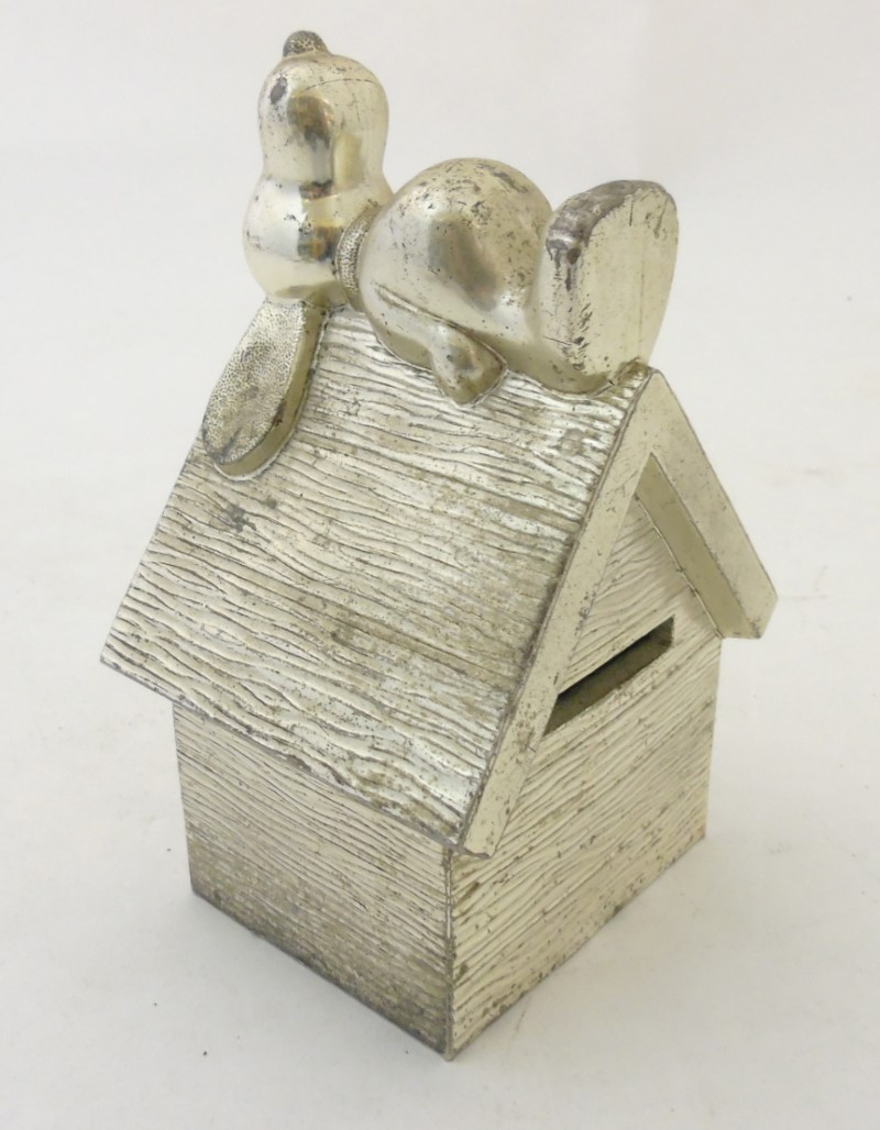 A silver plated money box entitled 'Snoopy' part of the 1958 - 1966 United Feature Syndicate Inc.