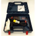 A cased Bosch 110 volt mains hammer drill CONDITION: Please Note - we do not make