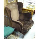 A brown upholstered wing back armchair CONDITION: Please Note - we do not make