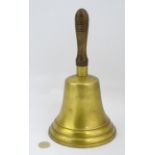 A large hand bell with wood handle,