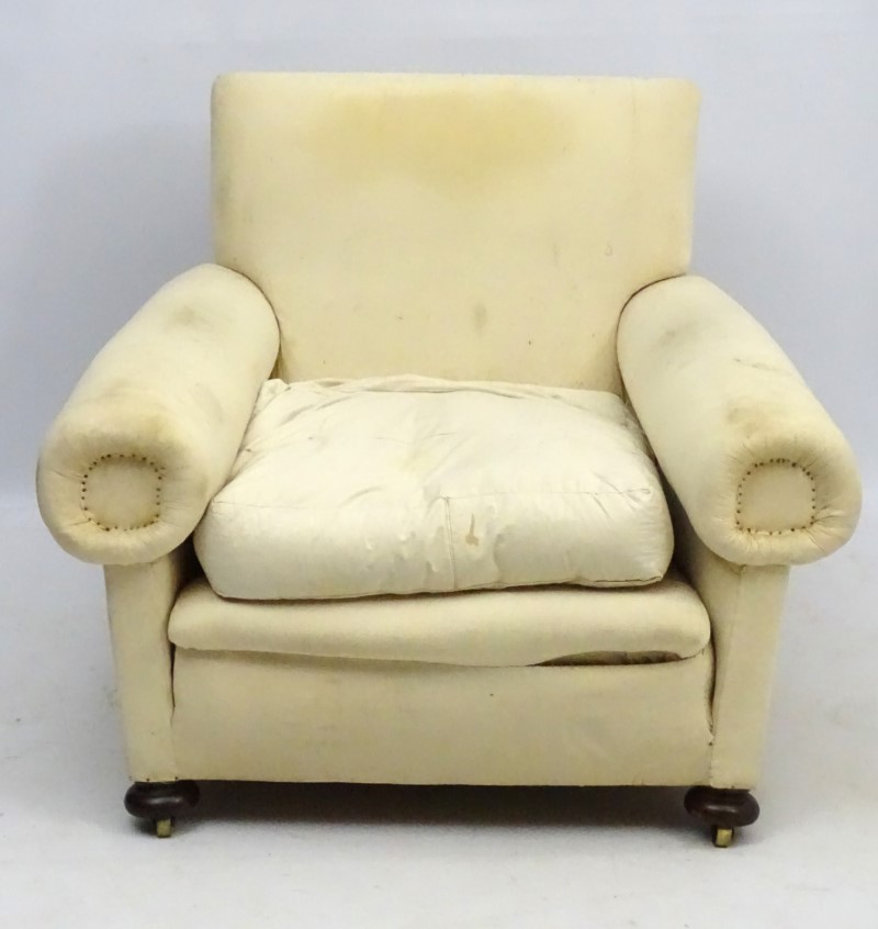 A late Victorian upholstered and overstuffed armchair with walnut bun feet. - Image 5 of 5