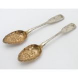 A pair of Scottish silver fiddle pattern teaspoons having embossed floral decoration to the gilded