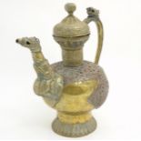 A large brass ewer with copper repousse and pierced decoration and having animal head etc detail.