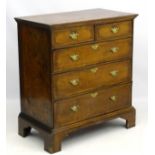 A Queen Anne style walnut chest of drawers comprising two short over three long drawers,