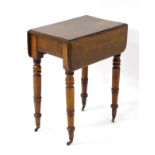 An early / mid 19thC mahogany drop flap table with single short drawer and raised on turned