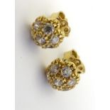 A pair of 18ct gold stud earrings set with white stones.