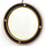 A mid 20thC circular mirror with blue glass surround and clear glass rosette decoration.