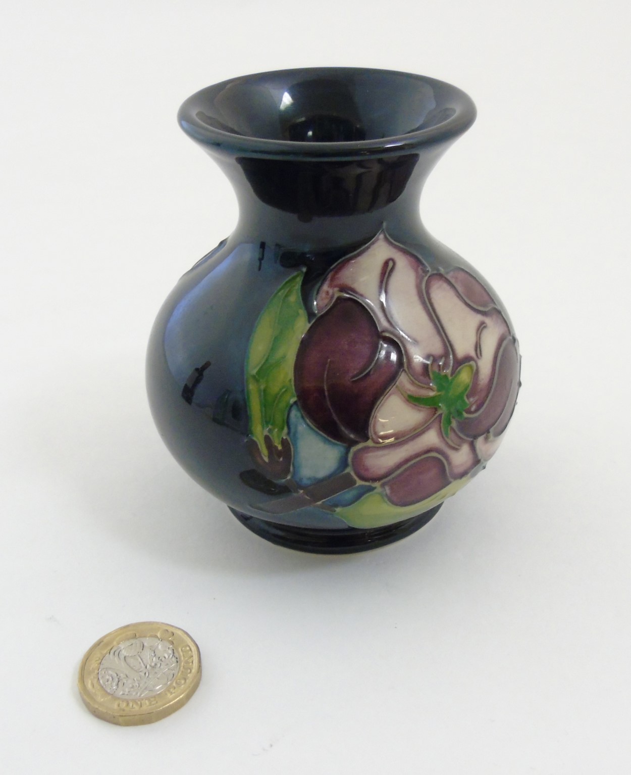 A 1994 Moorcroft Magnolia vase on dark blue ground, makers mark to base,