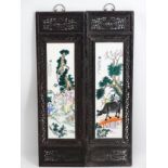 A pair of Chinese hardwood screens each with openwork decoration and an inlaid Chinese ceramic