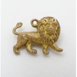 A vintage gilt metal pendant / charm formed as a lion 3/4" wide CONDITION: Please