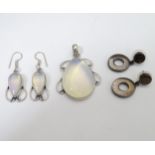 A silver pendant and drop earrings all set with moonstone like detail together with a pair of