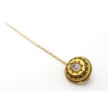 A 19thC gold and gilt metal stick pin set with large diamond .