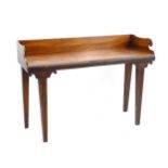 A William IV mahogany Irish serving table with scrolled up stand and carved front edge raised on