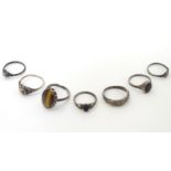 7 assorted rings including a silver ring set with tigers eye CONDITION: Please Note