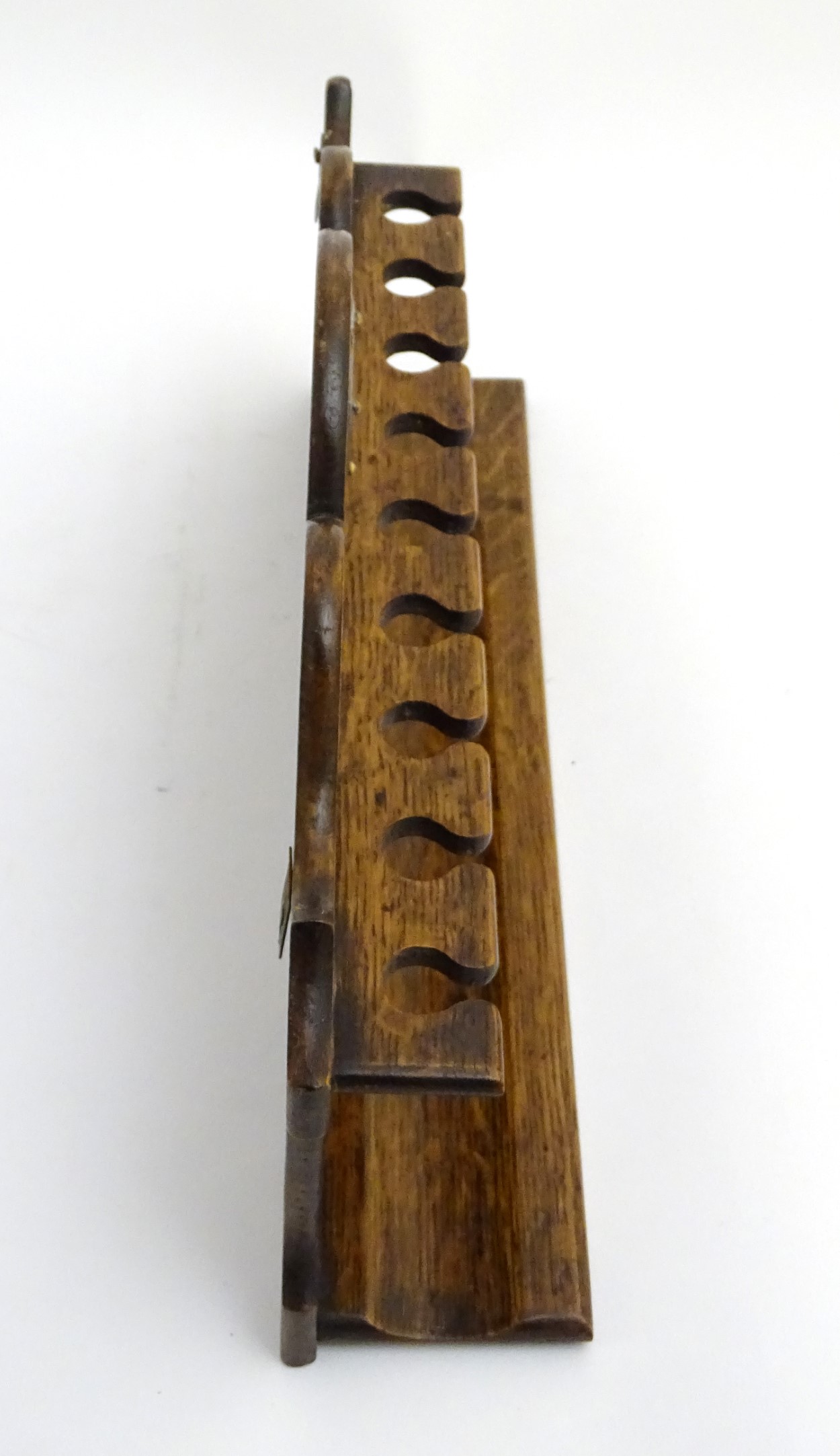 Pipe smoking: An early 20thC oak pipe rack, with provision for nine pipes, - Image 10 of 12