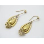 A pair of late 19thC / early 20thC gold and yellow metal drop earrings.