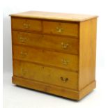 A Victorian stripped pine chest of drawers comprising two short over three long graduated drawers,