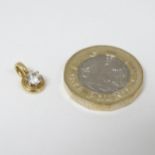 A diamond set pendant in gold mount .