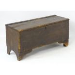 A 19thC small proportion six plank coffer, standing on bracket feet and with arched shaped sides.