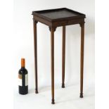 An early 19thC mahogany samovar stand with raised gallery top and pull out slide,
