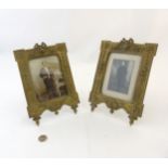 A pair of 19thC easel / strut photograph frames having cast brass Kent style frame with cabochon