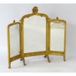 An early / mid 20thC gilt triptych mirror with arched floral tops and having blind fretwork