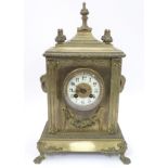 19 th C brass cased French mantel clock : a 8 day movement striking on a bell on the hour and half