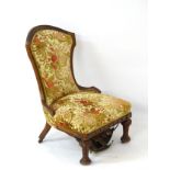 A late 19thC oak slipper chair with shield shaped back,