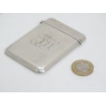 A silver visiting card case with hinged lid and canted corners.