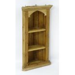 A Victorian pine corner cupboard with three shelves below a moulded cornice. 22” wide x 40” high.