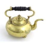 A late 19thC brass squat formed spherical shaped kettle with squat bun feet.