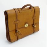 Church's: A leather briefcase with fabric lining and brass clasp.