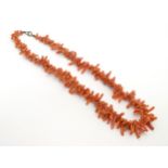A coral choker necklace of graduated branch coral beads.