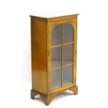 A mid / late 20thC glazed burr walnut cabinet with astragal glazed door containing two shelves,